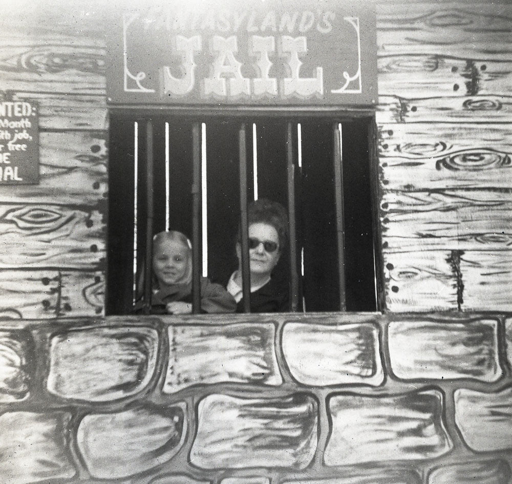 Girl and Adult Lady posing in the "Jail" window.