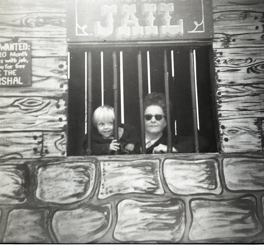 Boy and Adult Lady posing in the "Jail" window.